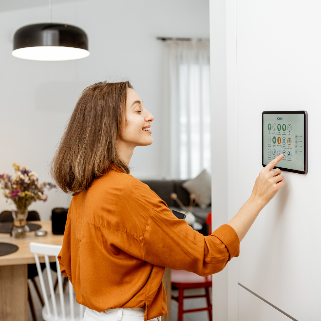 Young woman using smart home panel
